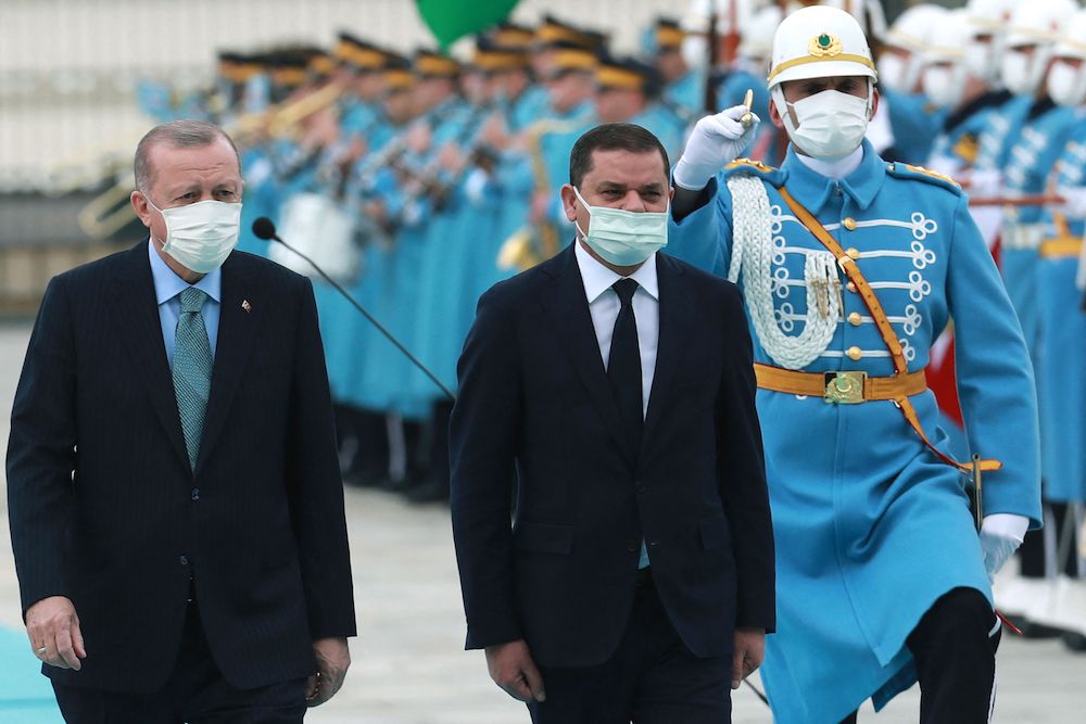 Turkish President Recep Tayyip Erdogan (L) and Libyan government of national unity prime minister Abdul Hamid Dbeibah (R) walk past honour guards during the official ceremony prior to their meeting in Ankara on April 12, 2021. (AFP/File Photo) Turkish President Recep Tayyip Erdogan (L) and Libyan government of national unity prime minister Abdul Hamid Dbeibah (R) walk past honour guards during the official ceremony prior to their meeting in Ankara on April 12, 2021. (AFP/File Photo)