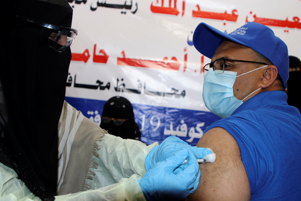A health worker receives the AstraZeneca COVID-19 vaccine at a medical center in Aden, Yemen April 20, 2021. (Reuters)