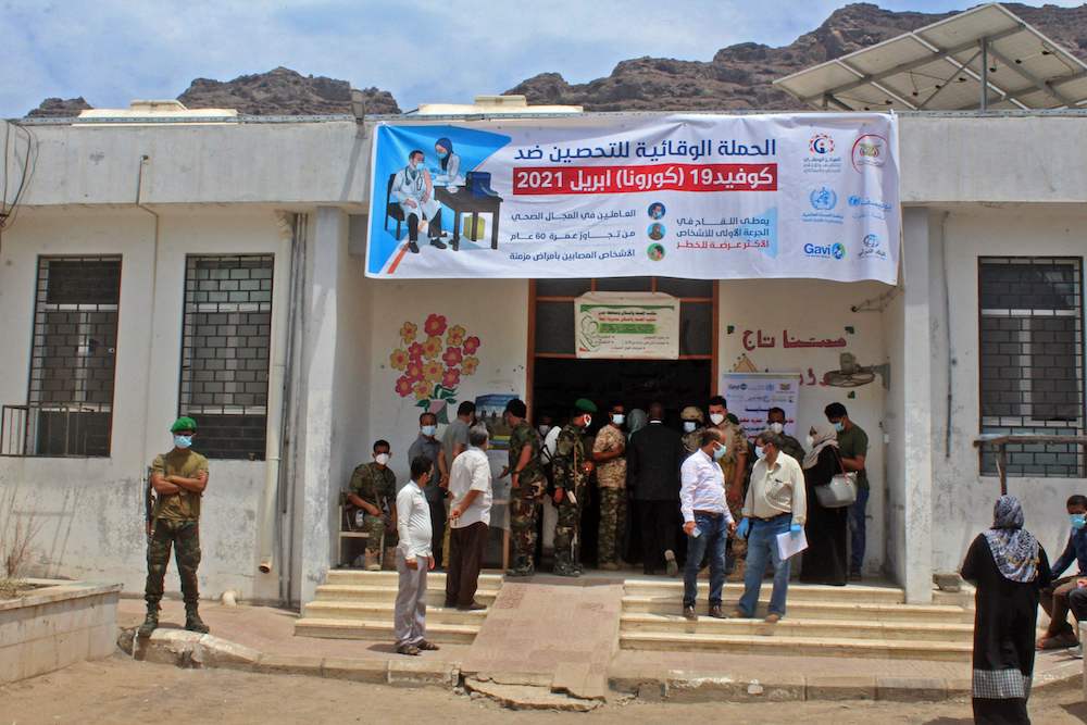 Yemenis gather outside a vaccination center in Al-Maala district of the southern city of Aden on April 20, 2021. (AFP)