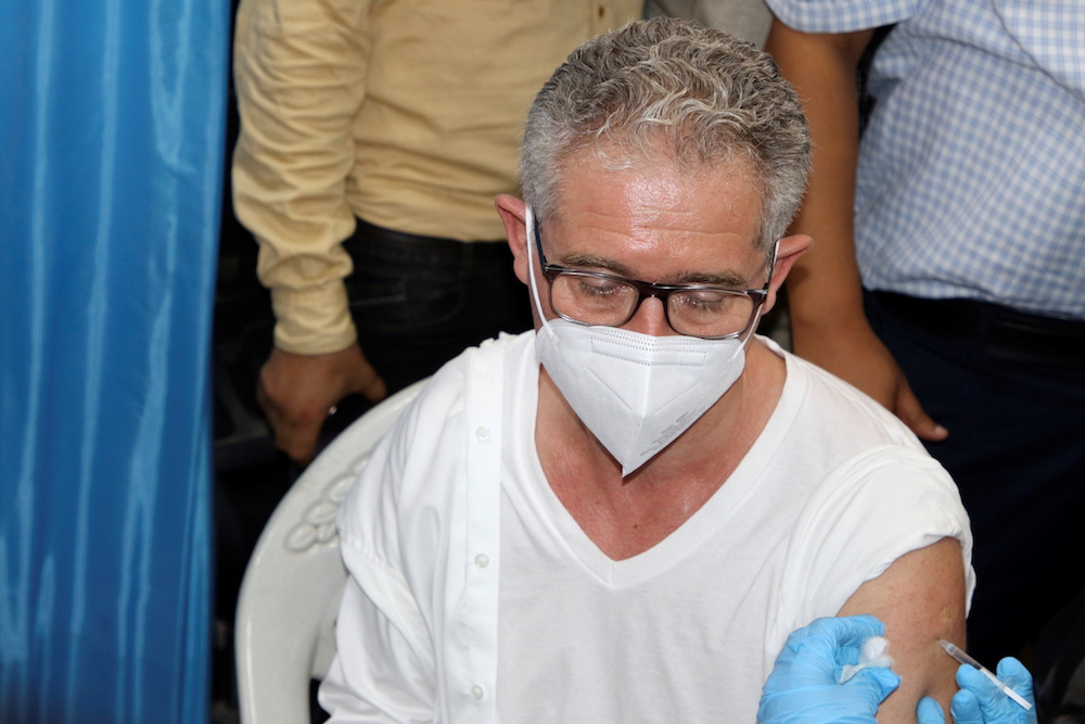 Philippe Duamelle, UNICEF’s representative in Yemen, receives the AstraZeneca COVID-19 vaccine at a medical center in Aden, Yemen April 20, 2021. (Reuters)