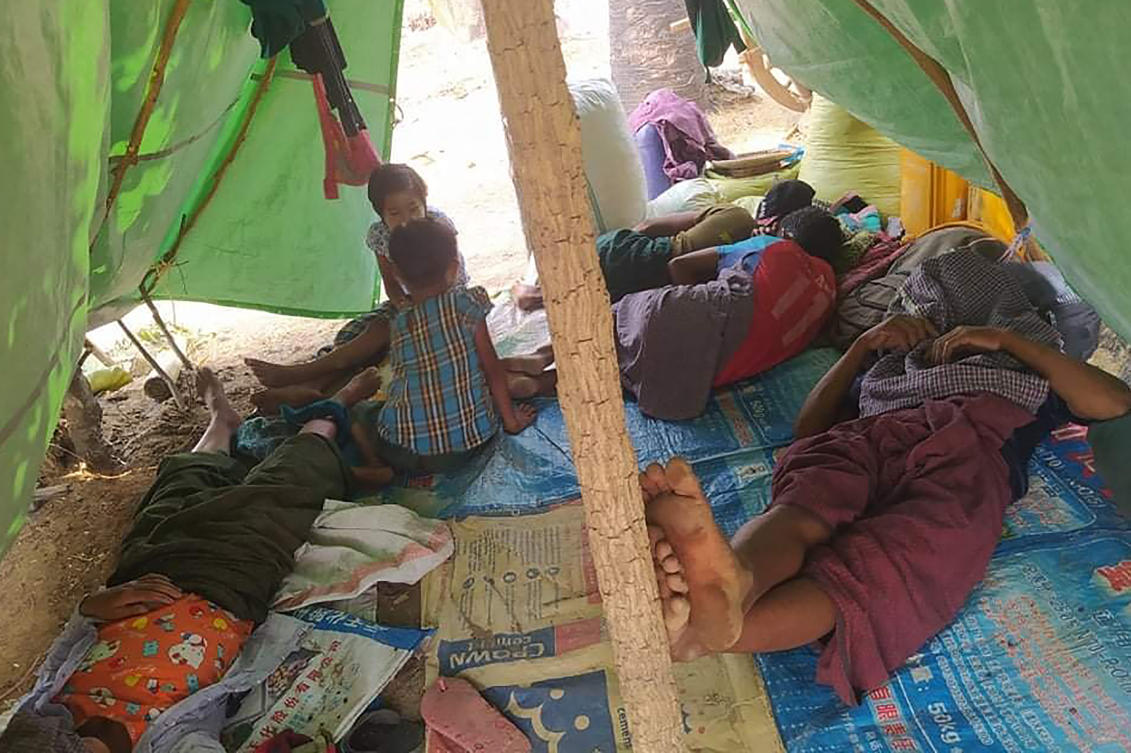 Displaced people resting in a makeshift shelter after fleeing their village in Kani township in Myanmar’s Sagaing region, following attacks in the area by the Myanmar military. (File/AFP)