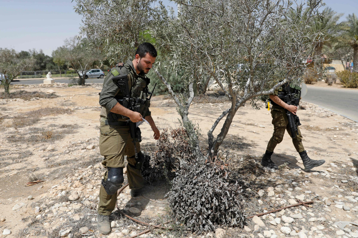 Israeli soldiers search for debris from a missile launched from Syria that landed in the vicinity of Israel's Dimona nuclear site on April 22, 2021. (AFP / Ahmad Gharabali)