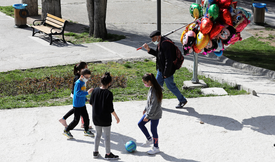 Children wearing masks to help protect against the spread of coronavirus, play at a park hours before a nationwide lockdown, in Ankara, Turkey, Wednesday, April 21, 2021. (AP)