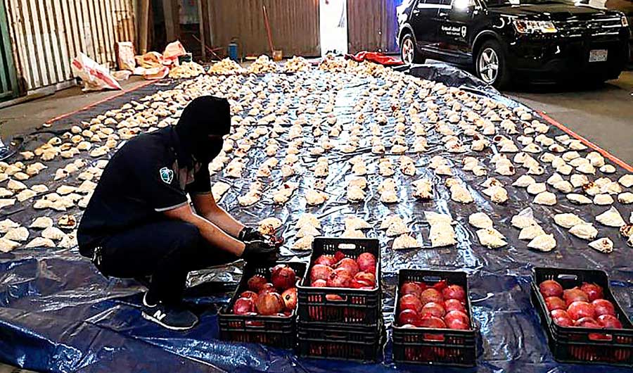 A Saudi Custom officer opens imported pomegranates, as customs foiled a attempt to smuggle millions of Captagon pills, which came from Lebanon. (SPA)