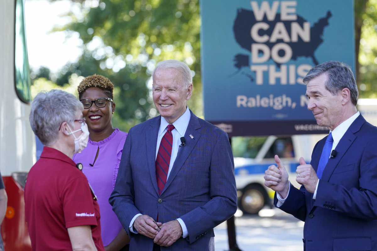 President Joe Biden and North Carolina Gov. Roy Cooper talk during a visit to a mobile vaccination unit in Raleigh, North Carolina. (AP Photo/Susan Walsh, File) 