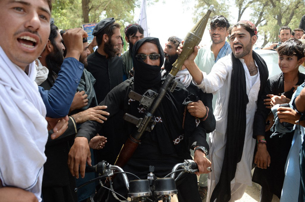 A Taliban fighter celebrates with villagers a ceasefire on the second day of Eid on the outskirts of Jalalabad on June 16, 2018. (AFP)