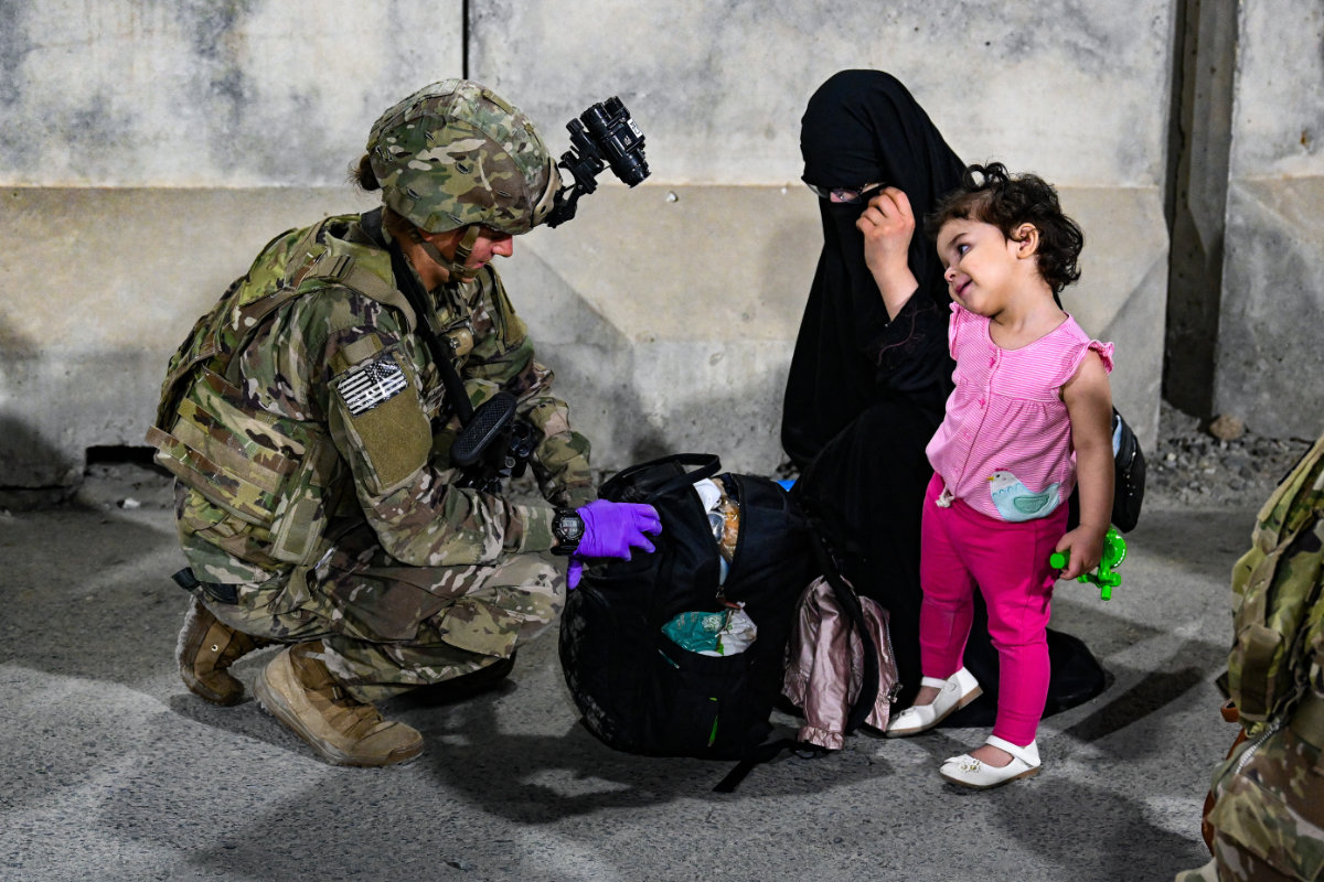A US paratrooper helps in the evacuation at Kabul airport. (AFP)