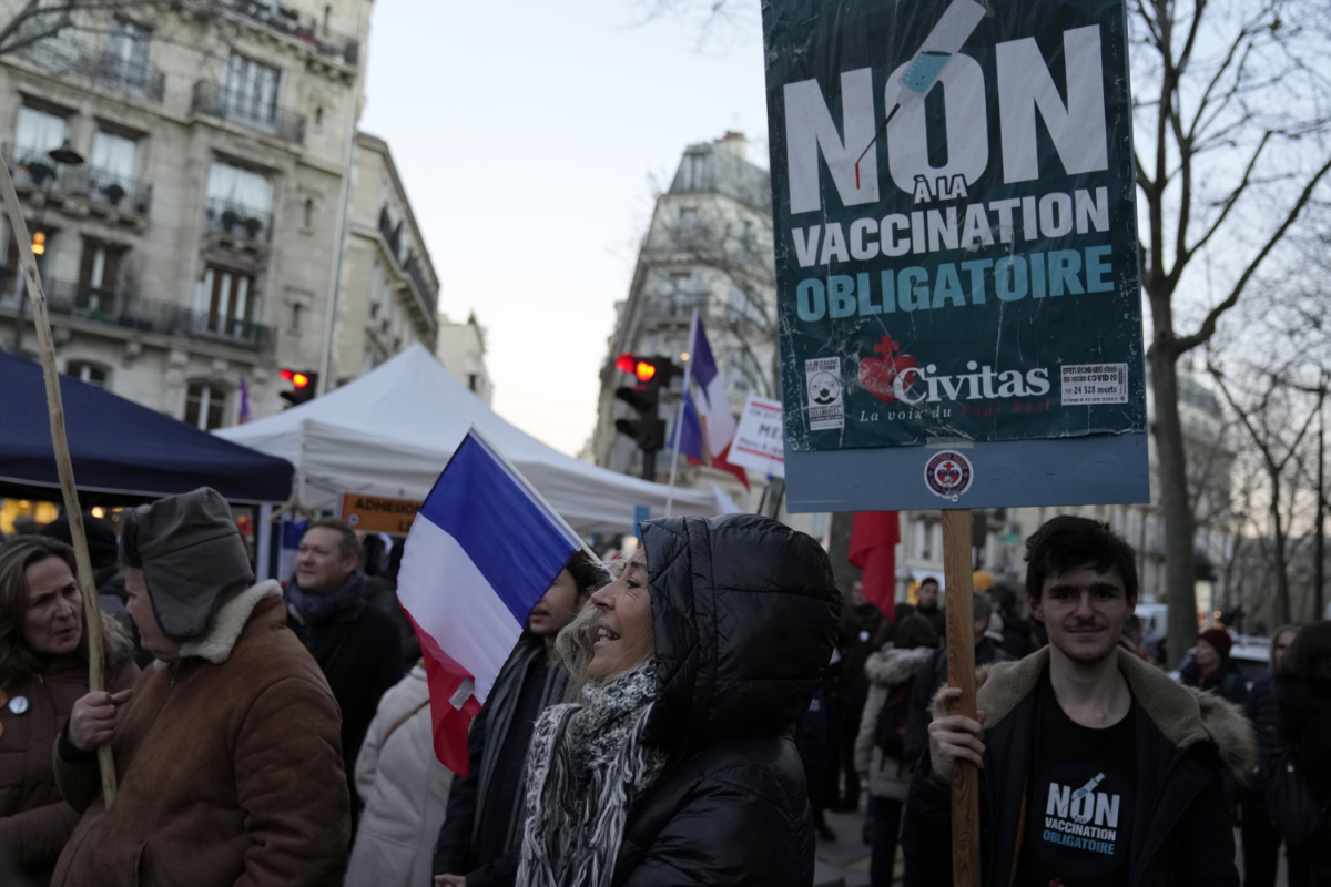 Demonstrators protest against mandatory vaccination rules against COVID-19 in Paris on Saturday, as nations across Europe move to reimpose tougher measures to stem a new wave of infections. (AP)