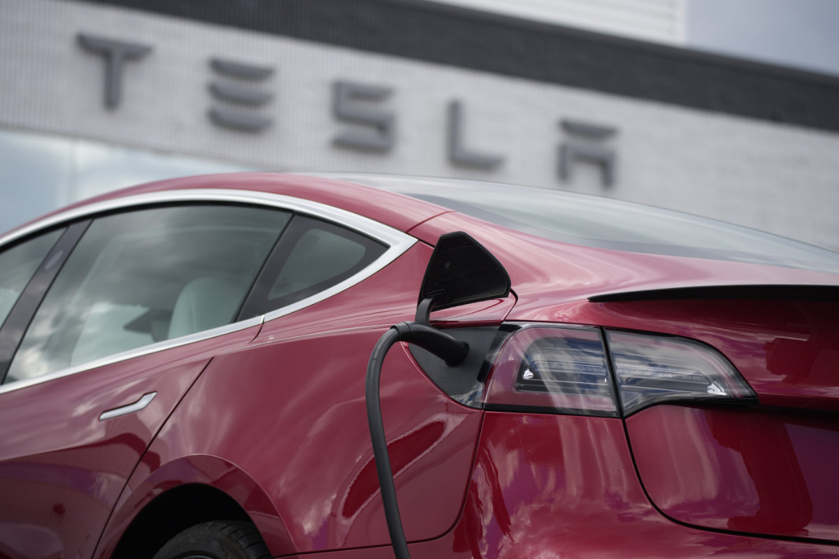 A 2021 Model 3 sedan charges at a Tesla dealership in Littleton, Colorado, on June 27, 2021. (AP Photo/David Zalubowski, File) 