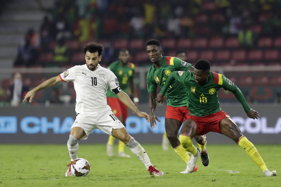 Egypt’s Mohamed Salah, left controls the ball challenged by Cameroon’s Vincent Aboubakar during the African Cup of Nations 2022 semifinal soccer match in Yaounde, Cameroon. (AP)