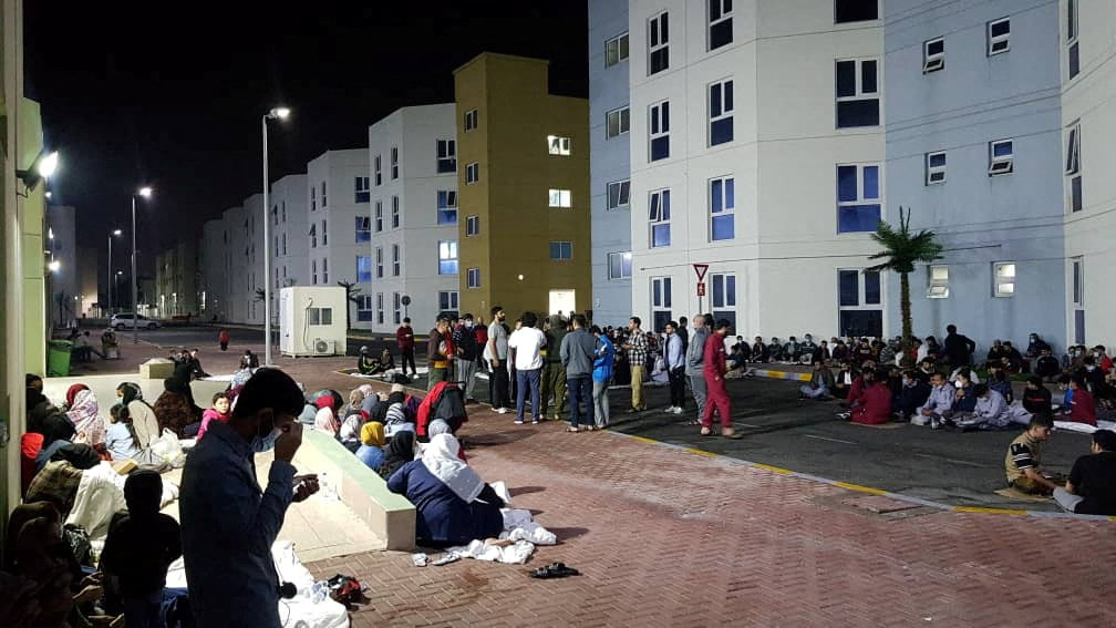 Afghans hold a rally at a Gulf facility in in Abu Dhabi, United Arab Emirates, to protest the lengthy US relocation process. (Rise to Peace/via REUTERS)