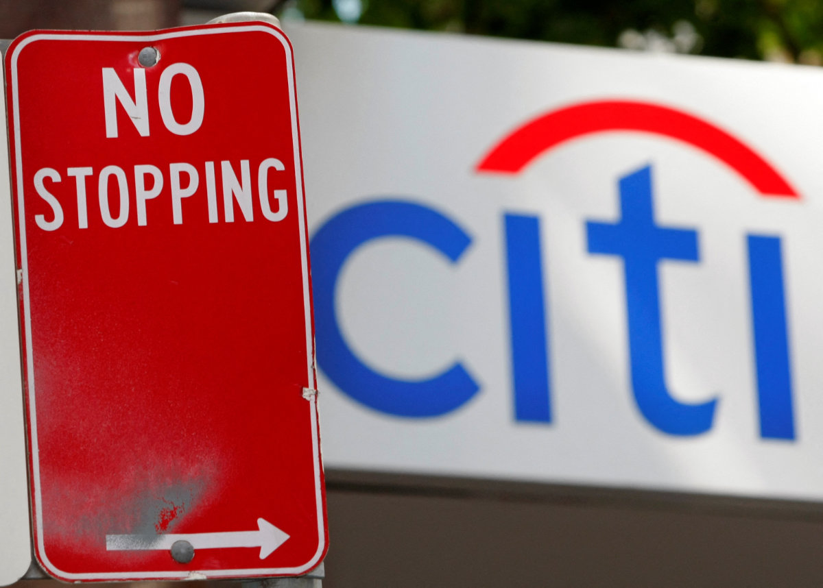 A Citibank branch sign is seen behind a road sign in central Sydney. (REUTERS/Tim Wimborne/File Photo)