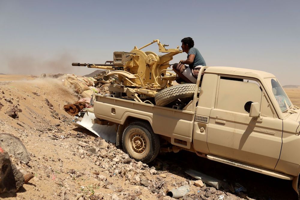 A Yemeni government fighter fires a vehicle-mounted weapon at a frontline position during fighting against Houthi fighters in Marib. (Reuters/File Photo)