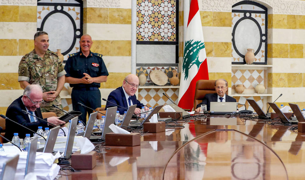 Lebanon's President Michel Aoun (R) and Prime Minister Najib Mikati (C) heading the cabinet meeting at the governmental palace in the capital Beirut on May 20, 2022. (AFP)