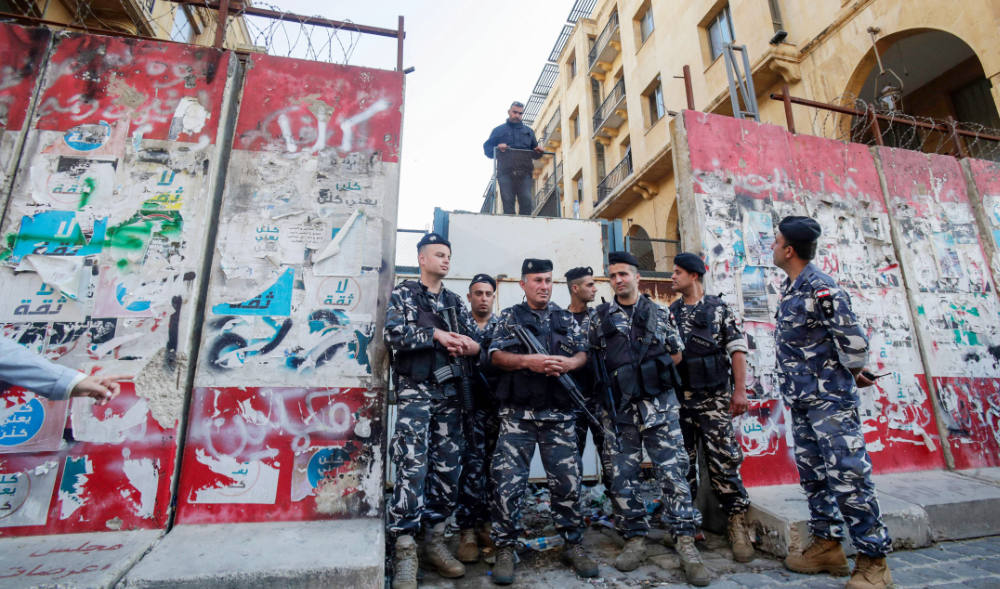Lebanese police stand guard after sections of the concrete barrier were removed at the entrance of the Lebanese parliament in Beirut on Monday. (AFP)