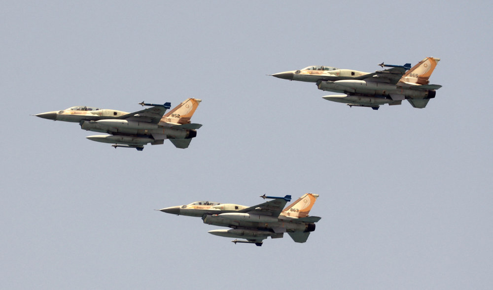 Israeli F-16 fighter jets perform during an air show over the beach in the Israeli coastal city of Tel Aviv on May 5, 2022. (AFP)