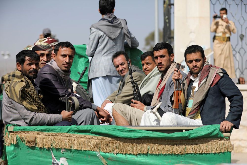 Armed Houthi followers riding on the back of a truck participating in a funeral of Houthi fighters. (Reuters/File Photo)