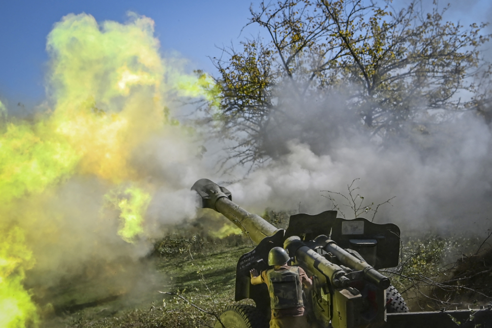 An Armenian soldier fires artillery on the front line during the ongoing fighting between Armenian and Azerbaijani forces over the breakaway region of Nagorno-Karabakh. (AFP file photo)