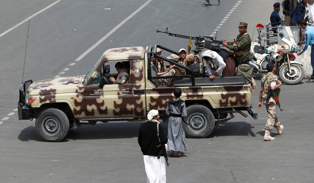 Supporters of the Yemeni Shiite Houthi movement guard a funeral procession, for members of the movement killed in a suicide bombing, in the capital Sanaa on October 14, 2014. (AFP)