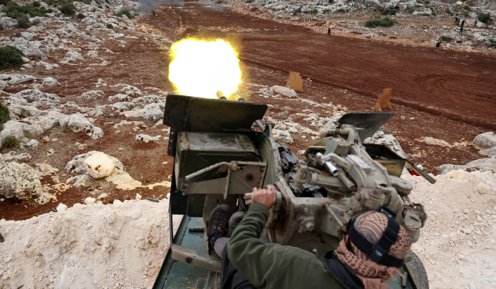A fighter affiliated with Syria's 'Hayat Tahrir al-Sham' (HTS) rebel-group, takes part in a military excercise with live ammunition, on the outskirts of the northwestern province of Idlib, on November 8, 2022. (AFP)