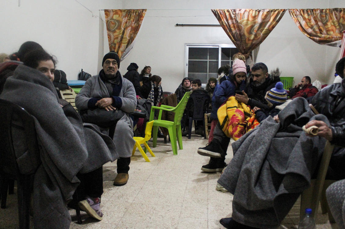 People sit together at a temporary shelter in the aftermath of the earthquake in Aleppo, Syria February 6, 2023. (Reuters)