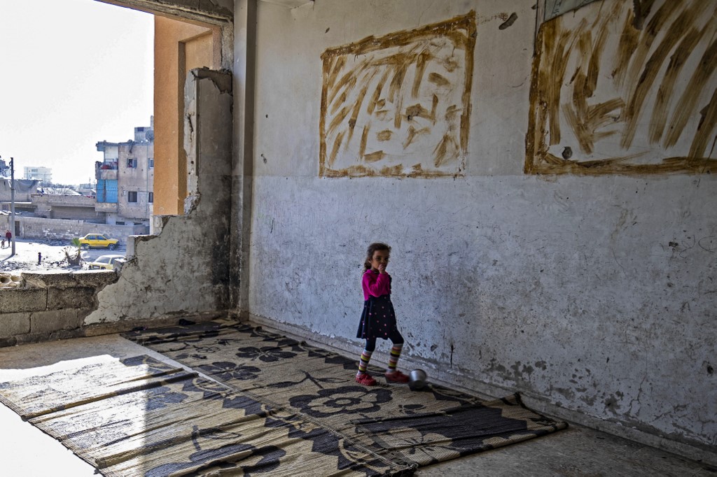 A displaced Syrian child living in war-damaged buildings, is pictured in Syria’s rebel-held northern city of Raqa. (AFP)