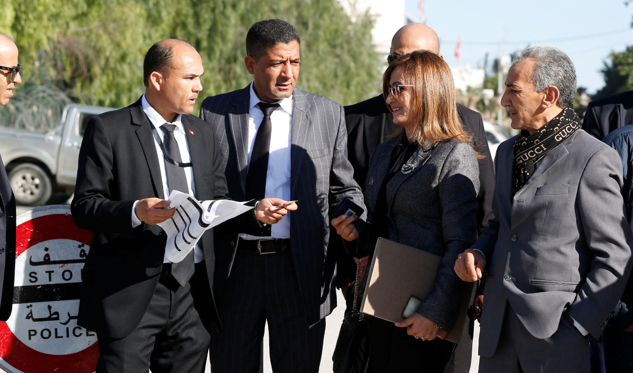 A woman member of Tunisia's new parliament stands at a security checkpoint as the parliament, elected in December and January in a vote with ultra-low turnout, holds its first session, in Tunis, Tunisia March 13, 2023. (Reuters)