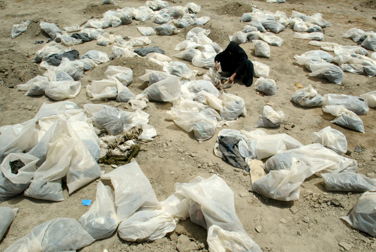 In this June 1, 2003 photo, an Iraqi woman looks inside plastic bags containing personal belongings for clues to identify her missing son at a mass grave in Mahawil, south of Baghdad, where some 5,000 of Iraqi Shi'ite Muslims were found. (Reuters file)Iraqi soldiers are seen running away on the banks of the Tigris river as US tanks roll into Baghdad, outside Saddam Hussein's presidential palace, on April 7, 2003. (AP) Iraqi soldiers are seen running away on the banks of the Tigris river as US tanks roll into Baghdad, outside Saddam Hussein's presidential palace, on April 7, 2003. (AP)