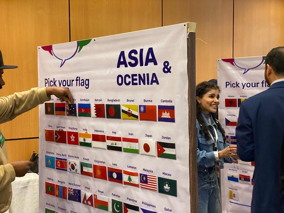 Attendees picking out the flags of the languages they speak and the languages they wish to learn and practice. (AN Photo/Dhai Al-Mutairi)
