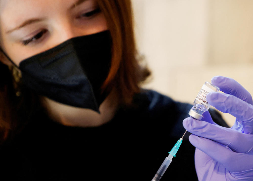 A volunteer prepares a syringe containing a dose of Comirnaty, the Pfizer-BioNTech vaccine against the coronavirus disease (COVID-19). (REUTERS)