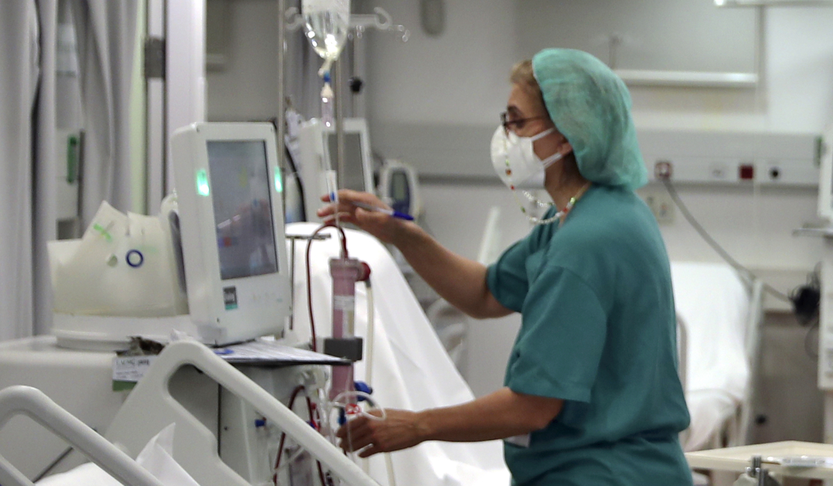 A nurse checks a patient undergoes dialysis. (AP)
