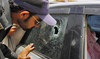 A police officer examines a bullet hole on the car of the Saudi consulate employee who was shot dead in Karachi on May 16, 2011. (AP/File Photo)