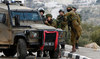 Israeli soldiers clash with Palestinian demonstrators in the West Bank village of Tuqua, south-east of Bethlehem. (AFP)
