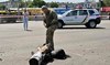 A police expert examines fragments of a missile after Russia fired a barrage of missiles for the second time in 24 hours.