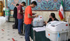 People vote during Friday’s runoff parliamentary elections in Tehran. (Reuters)