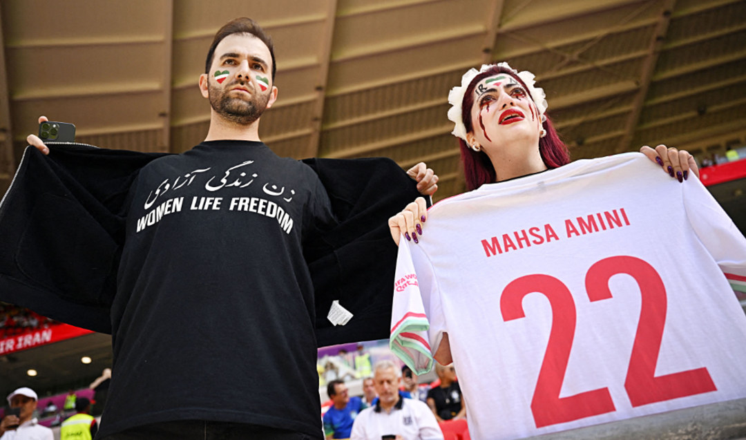 Demonstrators stage a protest at the soccer match between Wales and Iran. (AP)