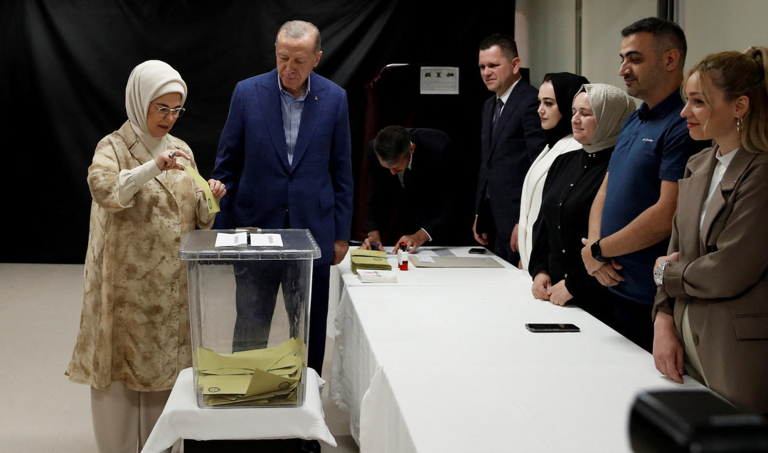 Turkish President Tayyip Erdogan and his wife Emine Erdogan vote at a polling station.