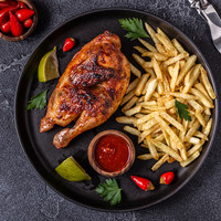 Half roasted chicken Piri Piri with french fries, top view. 