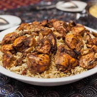 A traditional Emirati dish called chicken machboos (spiced chicken and rice). Machboos can be served with lamb or fish and is a popular dish across the Arabian Gulf region