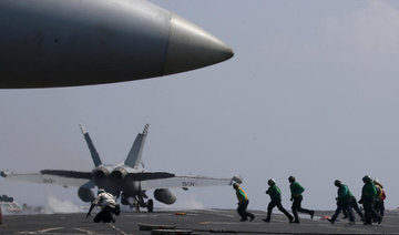 Top Philippine officials fly to US carrier in disputed sea