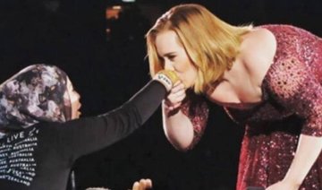 Adele stirs up social media after kissing hijab-wearing fan in Australia