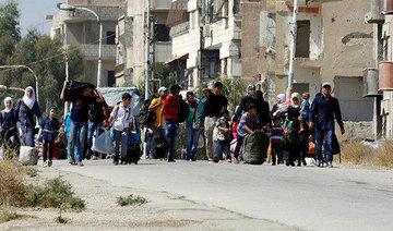 More Syrian fighters, families leave city of Homs under deal
