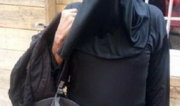Armed police stop man in a burqa in British city center