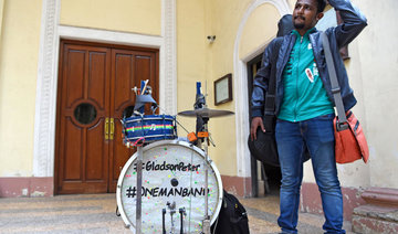 Indian one-man band blows, strums and sings against smoking