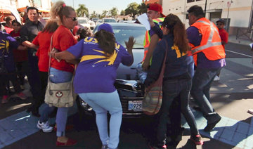 Six people injured as man drives car into US immigration rally
