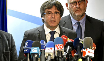 Ousted Catalan leader offers to meet PM outside Spain
