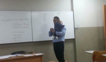 Photos of Lebanese professor carrying student’s baby during lecture melts hearts