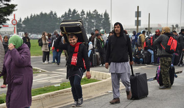 Migrants stream out of Calais Jungle before demolition