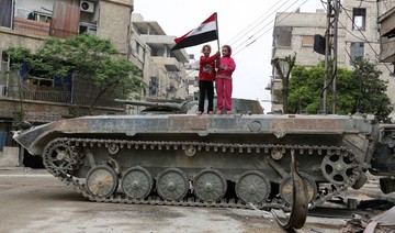 Syrian regime flag raised in Douma, rebels surrender heavy arms in Ghouta