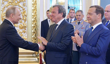 Russia's Putin begins new presidential term, keeps Medvedev as PM
